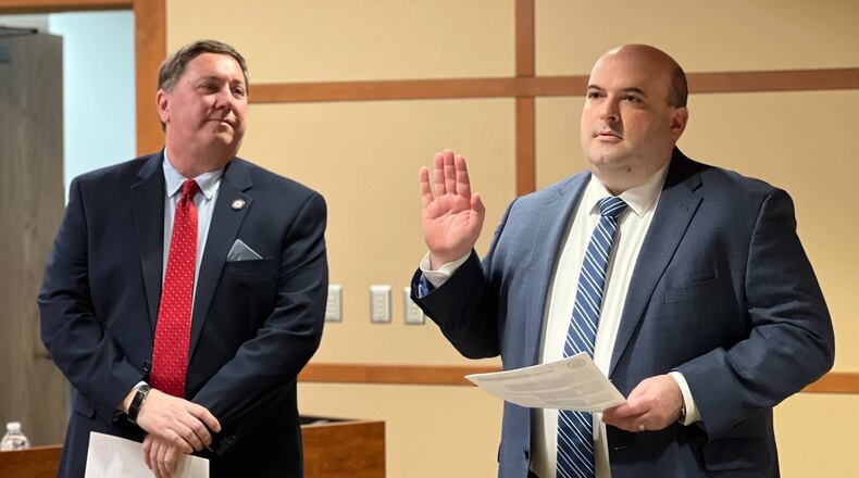 Russ Joseph is sworn in as deputy director of the Montgomery County Board of Elections on Wednesday, March 1, 2023, as elections director Jeff Rezabek looks on. AIMEE HANCOCK/STAFF
