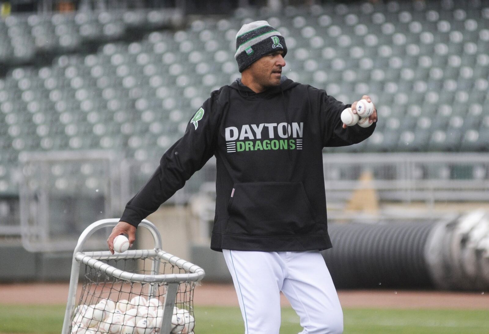 Dragons manager Luis Bolivar toss batting practice during a final preseason workout at Dayton’s Fifth Third Field on Wednesday, April 4, 2018. MARC PENDLETON / STAFF