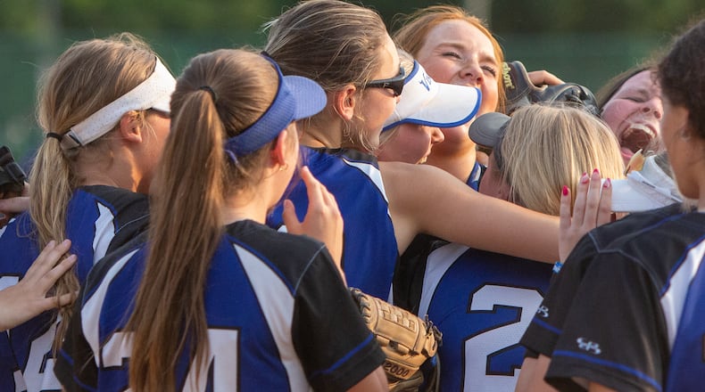 Miamisburg celebrates its first district softball title since 1994 Thursday after defeating Mason 11-8 at Hamilton High School. CONTRIBUTED/Jeff Gilbert