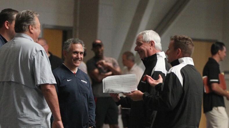 Keith Dambrot, center, talks to Bob Huggins, second from left, and other coaches at a recruiting even for top Ohio players at Capital University on June 29, 2019, in Bexley.