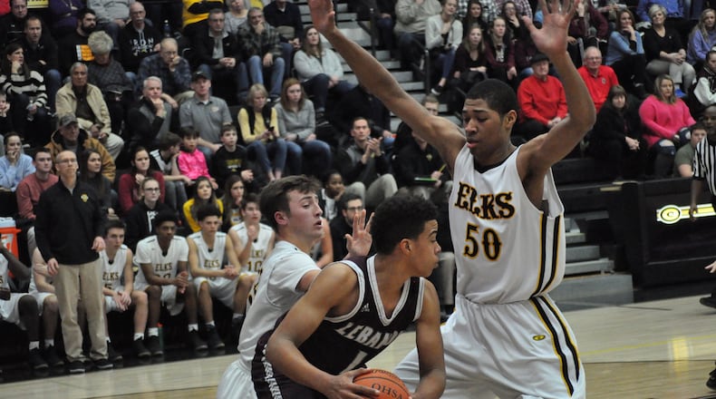 Lebanon’s Harrison Hoofkin tries to get something going offensively as Centerville sophomore Mo Njie (right) applies the pressure during Centerville’s 51-29 win at home Friday night. NICK DUDUKOVICH / CONTRIBUTED