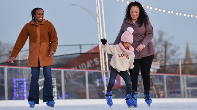 Corissa Johnson, 5, skates with her mom, Cristina Johnson, right, and aunt Kenisha Johnson at the Middletown Holiday Whopla ice skating rink Wednesday, Dec. 13, 2023, in downtown Middletown. NICK GRAHAM/STAFF