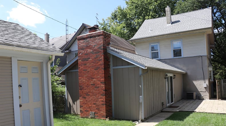 Patio doors open from the great room addition to a concrete brick patio and fenced back yard, which has a second concrete patio. The 1-car, detached garage has alley access as the home sits on a one-way street.
