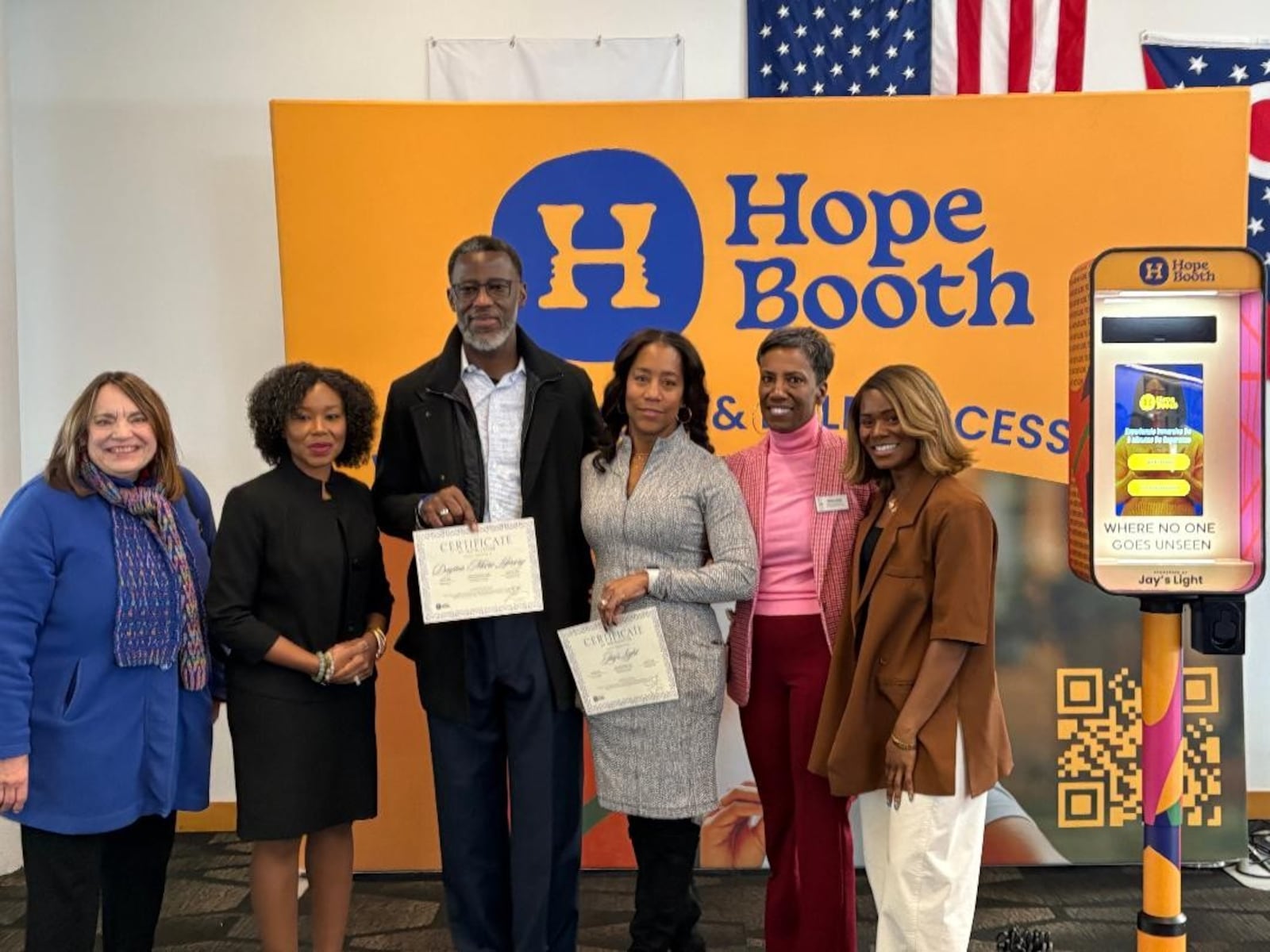 Left to right: Montgomery County Commissioner Carolyn Rice, Dayton Mayor Shenise Turner-Sloss, Anthony Grant, Christina Grant, Dayton Metro Library External Relations and Development Director Debi Chess and Hope Booth Founder/CEO Gloria Umanah. Photo by Russell Florence Jr.