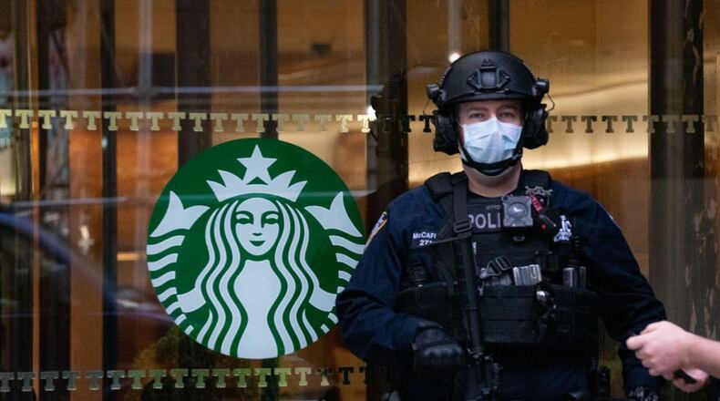 NEW YORK, NY - APRIL 14: A police officer wearing a mask stands watch at Trump Tower on April 14, 2020 in New York City. New York Gov. Andrew Cuomo and the governors of six other states said they would make a coordinated plan to reopen the regional economy. Joining New York in the coalition are New Jersey, Connecticut, Pennsylvania, Delaware, Rhode Island and Massachusetts. (Photo by David Dee Delgado/Getty Images)
