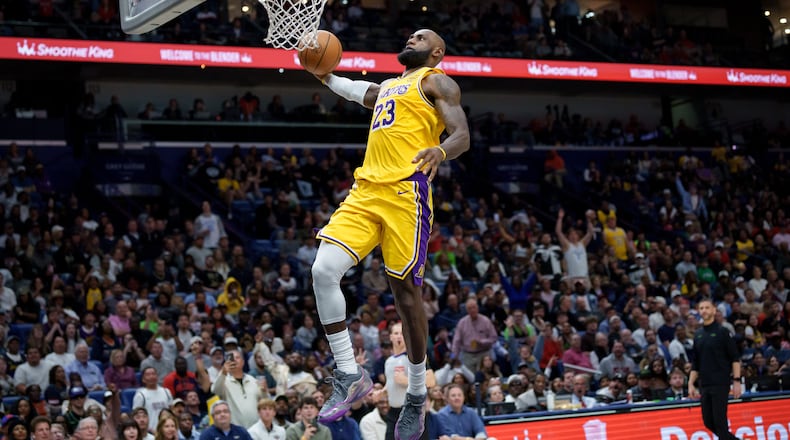Los Angeles Lakers forward LeBron James (23) breaks free for a dunk against the New Orleans Pelicans during the second half of an NBA basketball game in New Orleans, Tuesday, Jan. 6, 2026. (AP Photo/Matthew Hinton)