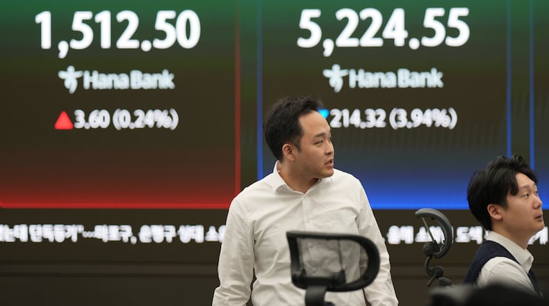 Dealers work near the screens showing the Korea Composite Stock Price Index (KOSPI), right, and the foreign exchange rate between U.S. dollar and South Korean won at a dealing room of Hana Bank in Seoul, South Korea, Monday, March 30, 2026. (AP Photo/Lee Jin-man)