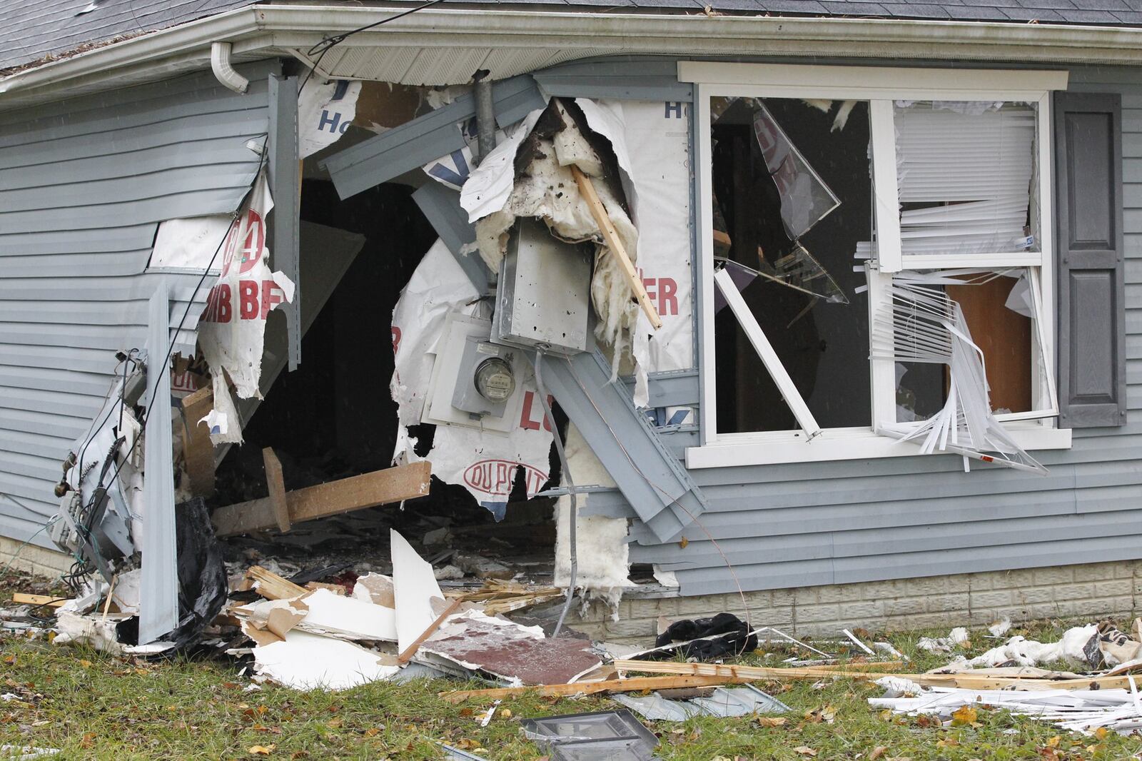 A mother and her 7-year-old son died Wednesday night after a car rammed into their house on Lilac Avenue in Dayton. CHRIS STEWART / STAFF