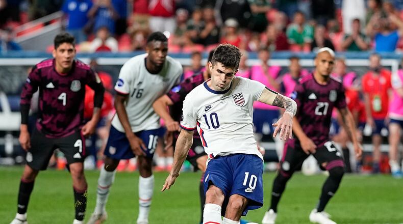 United States' Christian Pulisic (10) kicks a penalty kick for a goal against Mexico during extra time in the CONCACAF Nations League championship soccer match, Sunday, June 6, 2021, in Denver. (AP Photo/Jack Dempsey)