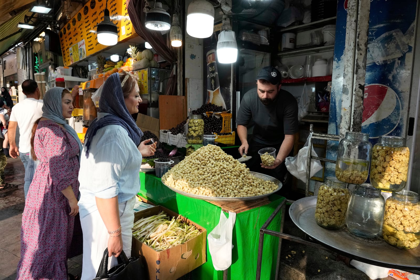 A fruit seller sells Mulberry at Tajrish traditional bazaar in northern Tehran, Iran, Friday, June 13, 2025. (AP Photo/Vahid Salemi)