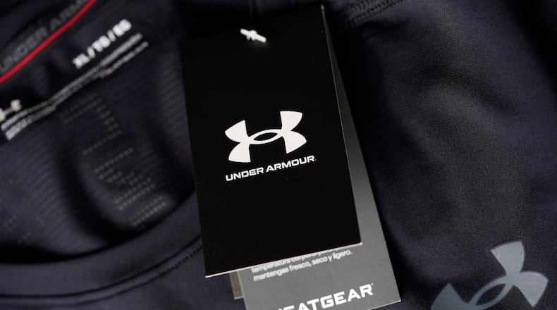 FILE - The company logo graces a sales tag on a compression shirt for sale in an Under Armour store in an outlet mall on May 3, 2021, in Lakewood, Colo. (AP Photo/David Zalubowski, File)