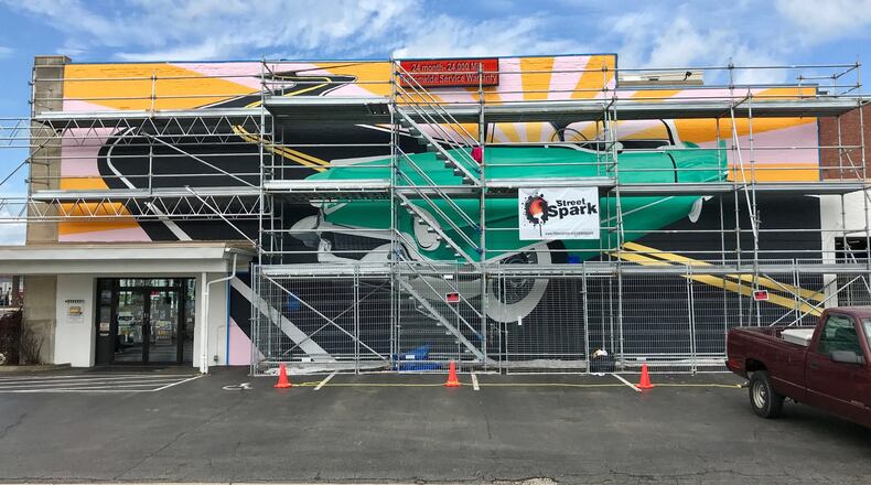 The mural “Hey Caddy-O” depicts a 1950s mint green Cadillac Coupe de Ville. The mural, which is part of this year’s StreetSpark program, is being painted on the side of the Jeff Pohlman Tire and Auto Service building at 736 High St. That same building, used to be a Cadillac dealership. Also, Hamilton shares a manufacturing past with Cadillacs. Fisher Body from the late 1940s through 1988 produced bodies for the brand. NICK GRAHAM/STAFF