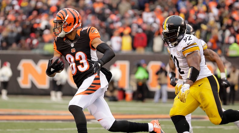 CINCINNATI, OH - DECEMBER 18: Tyler Boyd #83 of the Cincinnati Bengals runs the ball away from James Harrison #92 of the Pittsburgh Steelers during the third quarter at Paul Brown Stadium on December 18, 2016 in Cincinnati, Ohio. (Photo by Andy Lyons/Getty Images)