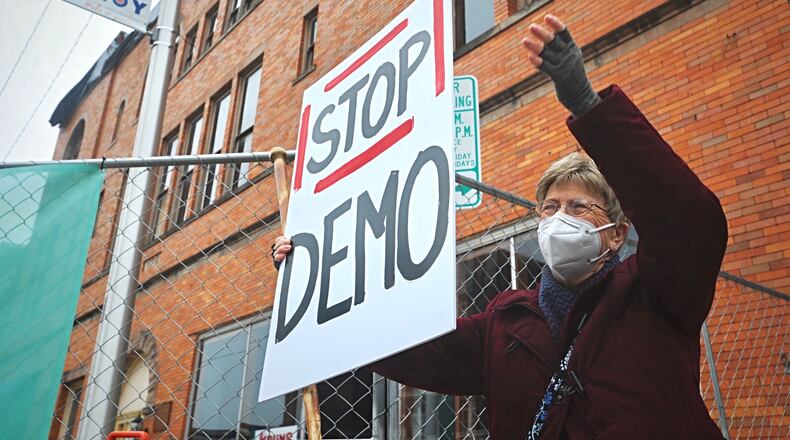 Troy resident Rosemary Jones protested the demolition of a Main Street building that housed an early county courthouse and an array of well-known businesses. The proposal to demolish the three-story building at 112-118 W. Main St. that was damaged during the January tornado that struck downtown Troy was voted ?????? Oct. 28, Wednesday afternoon.