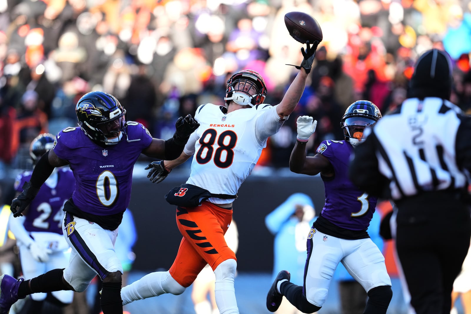Cincinnati Bengals tight end Mike Gesicki (88) is unable to complete a pass as Baltimore Ravens linebacker Roquan Smith (0) and cornerback Chidobe Awuzie (3) defend during the second half of an NFL football game, Sunday, Dec. 14, 2025, in Cincinnati. (AP Photo/Jeff Dean)