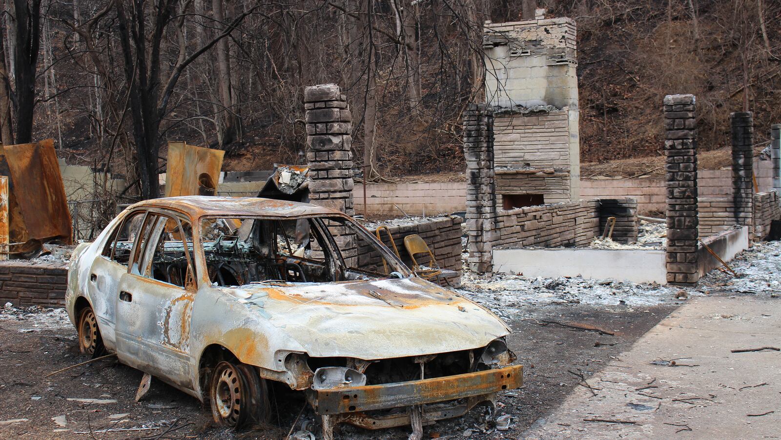 A fireplace, some rock towers and a fire-gutted car leave a sad remnant on winding U.S. Highway 321, near the heart of Gatlinburg. (Alan Solomon/Chicago Tribune/TNS)