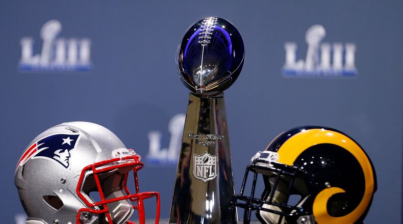 ATLANTA, GA - JANUARY 30:  Detail of the Lombardi Trophy and the helmets of the New England Patriots (left) and the Los Angeles Rams prior to NFL Commissioner Roger Goodell speaking during a press conference during Super Bowl LIII Week at the NFL Media Center inside the Georgia World Congress Center on January 30, 2019 in Atlanta, Georgia.  (Photo by Mike Zarrilli/Getty Images)