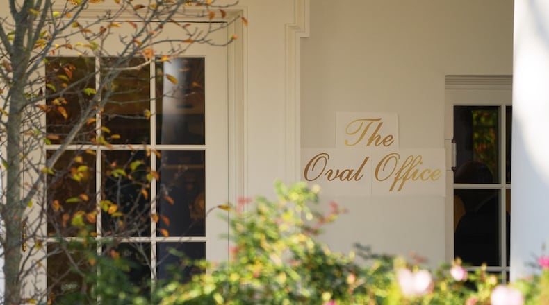 A sign is seen outside the Oval Office before President Donald Trump walks out to board Marine One on the South Lawn of the White House, Wednesday, Nov. 5, 2025, in Washington. (AP Photo/Evan Vucci)