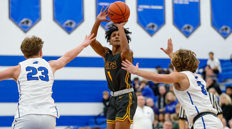 Cutline: Springfield High School freshman CJ Wallace shoots a 3-pointer over Springboro's Maxim Butler (3) and Carson Gutman (23) during their game on Friday night in Springboro. The Panthers won 69-52. Michael Cooper/CONTRIBUTED