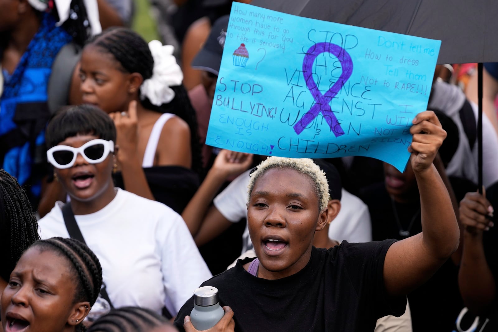 Activists chant slogans as they hold placards during the women's protest and hand over of a petition demanding that gender-based violence and femicide be declared a national disaster, at the Union Buildings in Pretoria, South Africa, Friday, April 11, 2025. (AP Photo/Themba Hadebe)