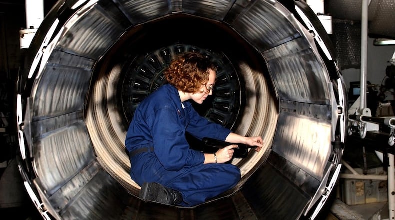 Petty Officer 2nd class Dawn Leclair works on a General Electric F110-GE-400 jet engine aboard the aircraft carrier USS Harry S. Truman in the Persian Gulf in 2004. DoD photo by Airman Kathaleen Knowles,