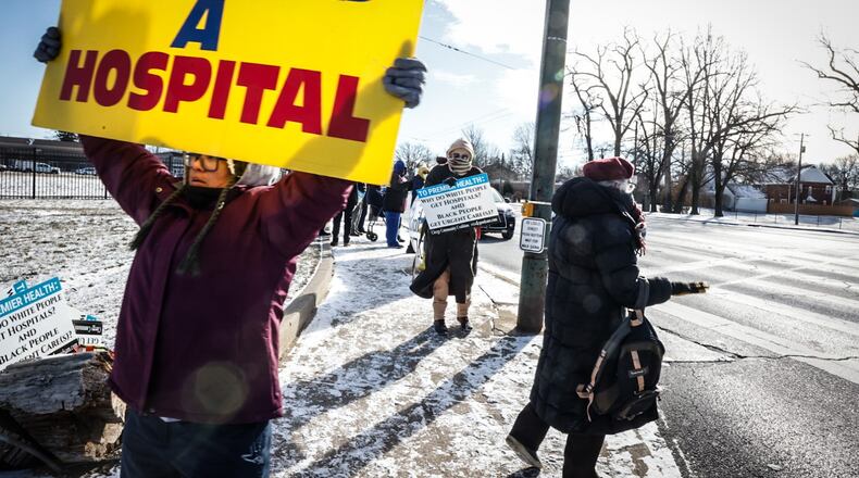 April C. Young from Dayton is joined by about a dozen protesters on Jan. 17, 2024 at the intersection of Salem Ave. and Philadelphia Dr., the site of the former Good Samaritan Hospital. The group says they want a hospital or a free-standing ER for the community instead of the new Premier Health YMCA facility that is there. JIM NOELKER/STAFF