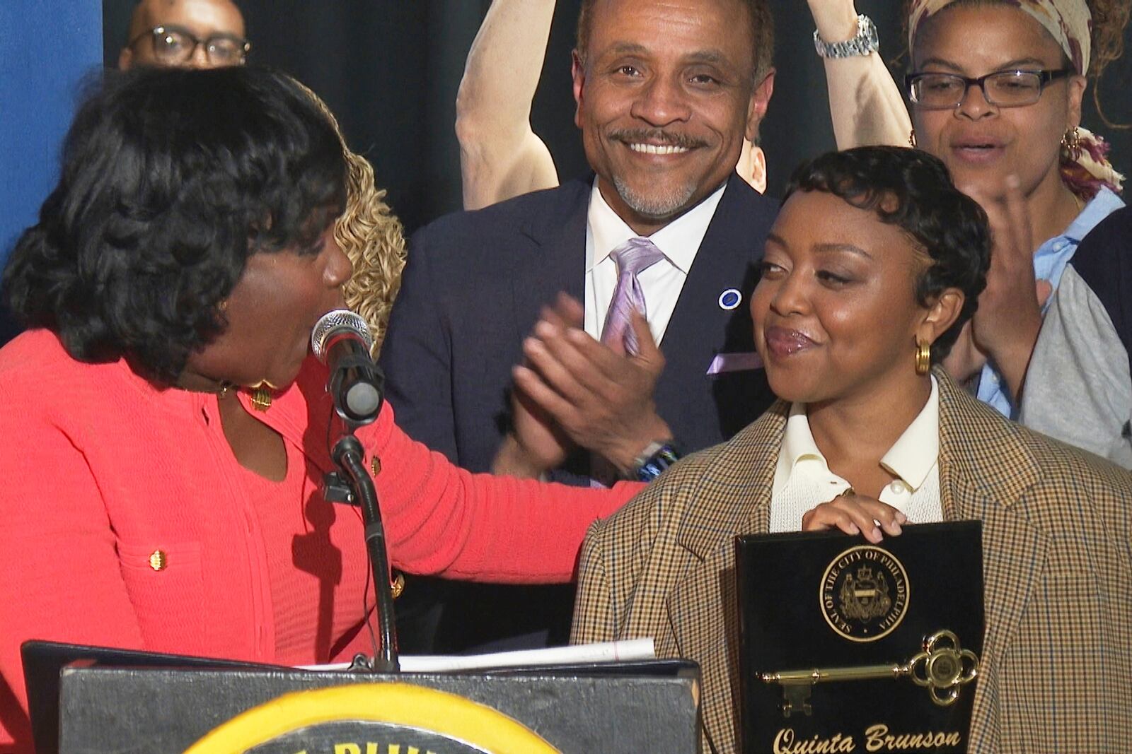 In this image made from video, Philadelphia's Mayor Cherelle Parker, left, honors actor Quinta Brunson with a key to the city in a ceremony dedicating a mural at Brunson’s alma mater, Andrew Hamilton School, which was the inspiration for her award-winning show “Abbott Elementary” Wednesday, May 28, 2025, in Philadelphia. (AP Photo/Tassanee Vejpongsa)