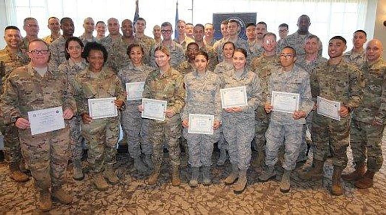 Col. Thomas Sherman (left), 88th Air Base Wing and installation commander, and Chief Master Sgt. Stephen Arbona (right), 88th Air Base Wing command chief, stand with the newest Team Wright-Patterson enlisted promotees during a ceremony at the Wright-Patterson Club Aug. 29. (U.S. Air Force photo/Thomas Lewis)