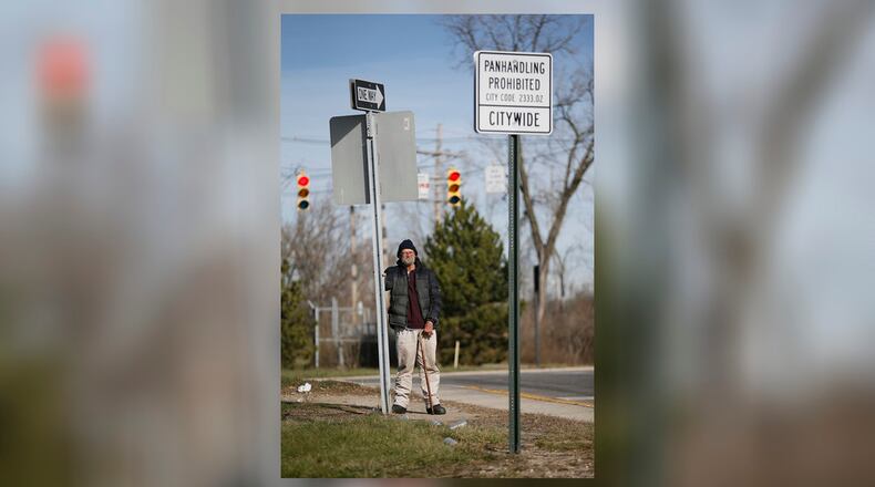 Despite the city's new sign outlawing panhandling, Tom Holbrook, 57, stands at the exit ramp from 315 to Long Street in Columbus waiting for drivers to give him enough money for a cigar and beer on Wednesday, Jan. 6, 2016. (Adam Cairns / The Columbus Dispatch)