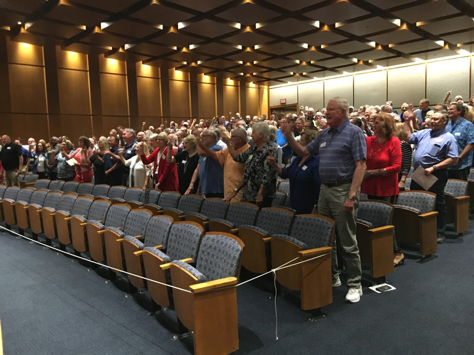 Members of the Delphi Salaried Retirees Association stood and chanted "Pass this bill" in September at a Sinclair Community College auditorium. THOMAS GNAU/STAFF