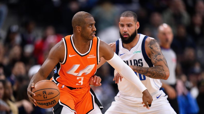 Los Angeles Clippers guard Chris Paul (3) controls the ball under pressure from Dallas Mavericks forward Caleb Martin during the first half of an NBA basketball game Saturday, Nov. 29, 2025, in Inglewood, Calif. (AP Photo/William Liang)