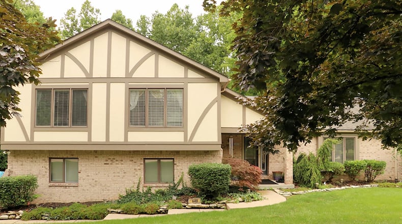 The 4-bedroom, brick-and-stucco house has about 2,930 sq. ft. of living space and a flexible lower level. A concrete driveway leads to the side-entry, 2-car garage. CONTRIBUTED PHOTO BY KATHY TYLER