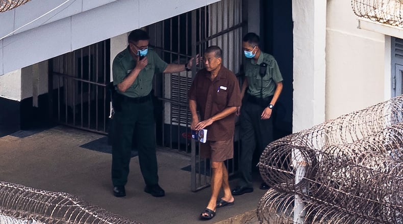 FILE - Jimmy Lai walks through the Stanley prison, in Hong Kong, July 28, 2023. (AP Photo/Louise Delmotte, File)