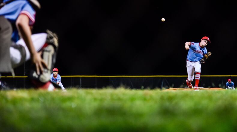 Storm Club baseball team pitcher Ethan Johnson throws a pitch during their game against Dayton Impact as baseball action started up again just after midnight Tuesday morning, May 26 at West Side Little League fields in Hamilton. The two games started at 12:15 a.m. and didn’t finish up until after 2 a.m. NICK GRAHAM / STAFF