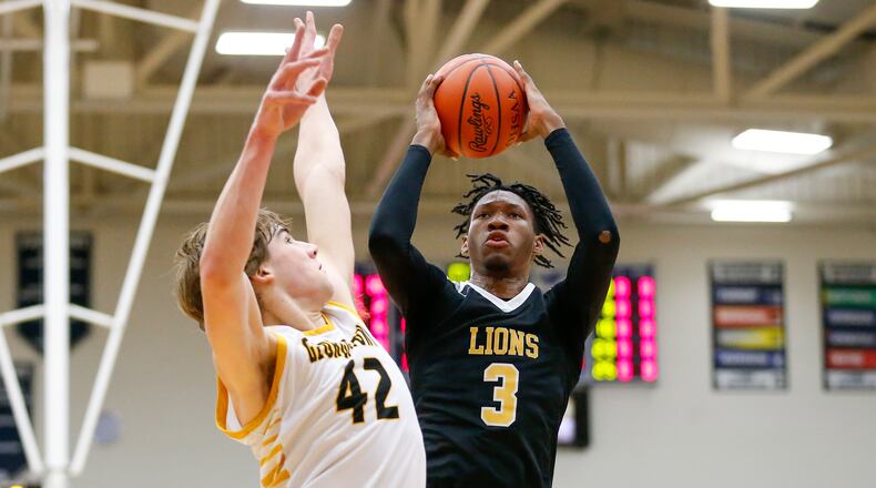 Meadowdale junior Lee Benson shoots the ball over Georgetown's Nate Kratzer on Wednesday, March 9, 2022, at Kettering's Trent Arena. The G-Men won 65-42. Contributed photo by Michael Cooper