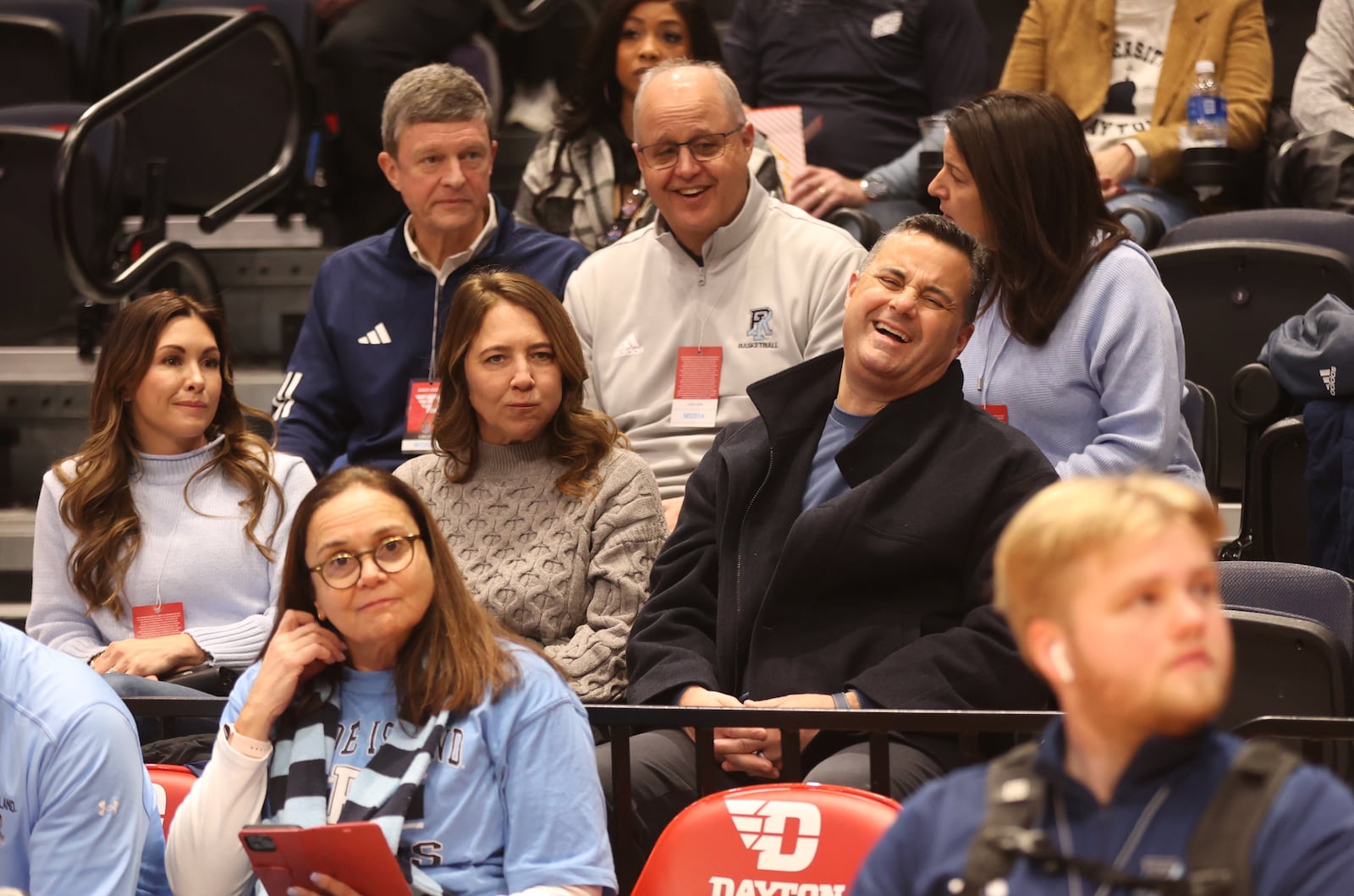 Xavier coach Sean Miller laughs before Rhode Island's game against Dayton on Saturday, Jan. 20, 2024, at UD Arena. Miller came to watch his brother Archie Miller coach. At left is Morgan Miller, Archie's wife, and Amy Miller, Sean's wife, is at center. David Jablonski/Staff