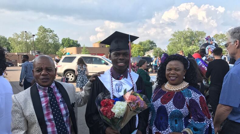 Bibebibyo Seko (center) and his parents, Mbuto (left) and Sela. TOM ARCHDEACON / STAFF