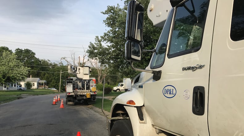 DP&L trucks were parked on Fruedenberger Ave. on the west side of Dayton as crews worked to restore power. Storms on Tuesday and Thursday knocked out service to tens of thousands of customers. Most has been restored, but a few patches of outages remained Thursday evening. GRANT PEPPER/STAFF