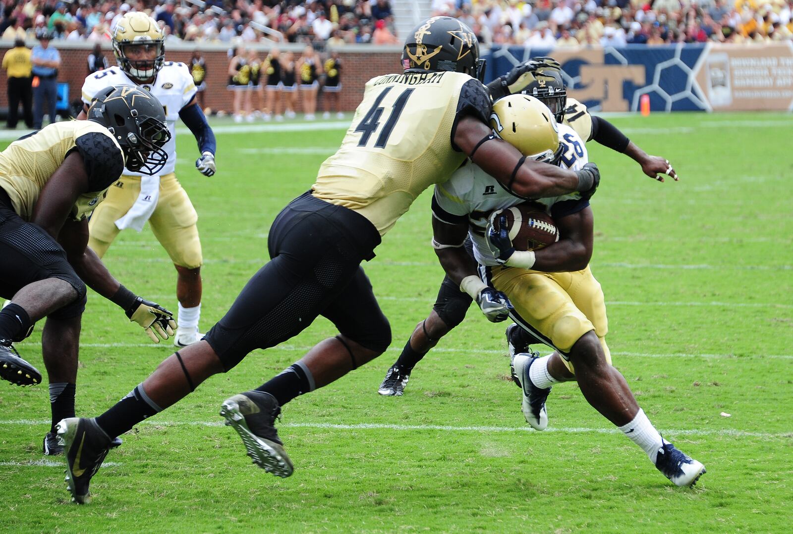 ATLANTA, GA - SEPTEMBER 17: Dedrick Mills #26 of the Georgia Tech Yellow Jackets eludes the tackle attempt by Zach Cunningham #41 of the Vanderbilt Commodores to score a touchdown at Bobby Dodd Stadium on September 17, 2016 in Atlanta, Georgia. (Photo by Scott Cunningham/Getty Images)