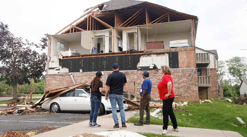 From left, Malyssa Suarez and Steve Cooper, both with the Federal Emergency Management Agency, Ahmed Hossain, of the Small Business Administration, and Brigitte Bouska, with the Ohio Emergency Management Agency, conduct a joint preliminary assessment of tornado-damaged buildings on Wednesday, June 5, at the Woodland Hills Apartments in Trotwood. CHRIS STEWART / STAFF