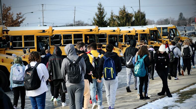 Stebbins high school students prepare to board buses after their first day back to school Tuesday, Jan. 18, 2022. Mad River school district had been doing online learning since last Thursday. MARSHALL GORBY \STAFF