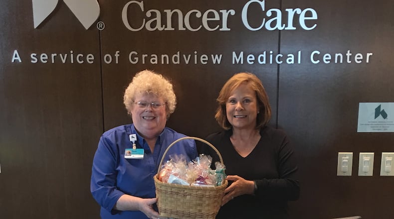 When two of her closest friends were battling cancer eight years ago, Washington Township resident, Sue Forrest, decided to provide comfort to them by knitting Comfee Caps for them to wear. Forrest, left, presented some caps to patients at theKettering Health Network Cancer Center.