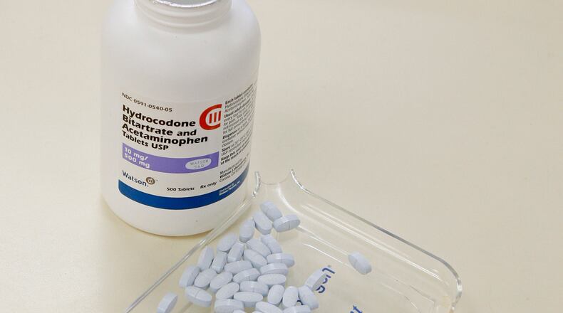 A pharmacy technician poses for a picture with some of them most widely used prescription painkillers, hydrocodone and acetaminophen tablets. AP Photo
