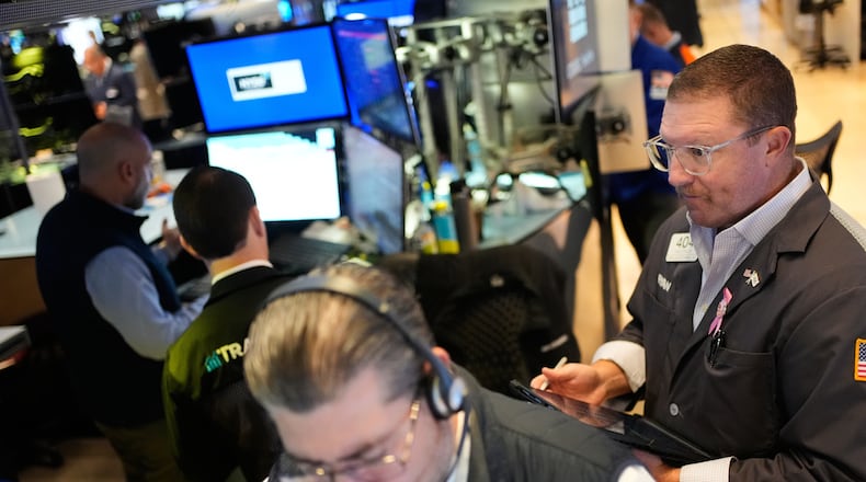 Ryan Falvey, right, works on the floor at the New York Stock Exchange in New York, Wednesday, Oct. 29, 2025. (AP Photo/Seth Wenig)