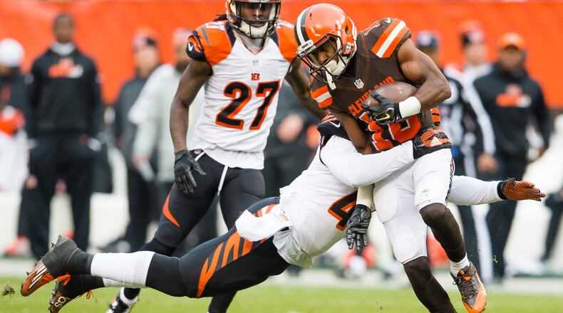CLEVELAND, OH - DECEMBER 6: Outside linebacker P.J. Dawson #47 of the Cincinnati Bengals tackles Wide Receiver Darius Jennings during the second half at FirstEnergy Stadium on December 6, 2015 in Cleveland, Ohio. The Bengals defeated the Browns 37-3. (Photo by Jason Miller/Getty Images)