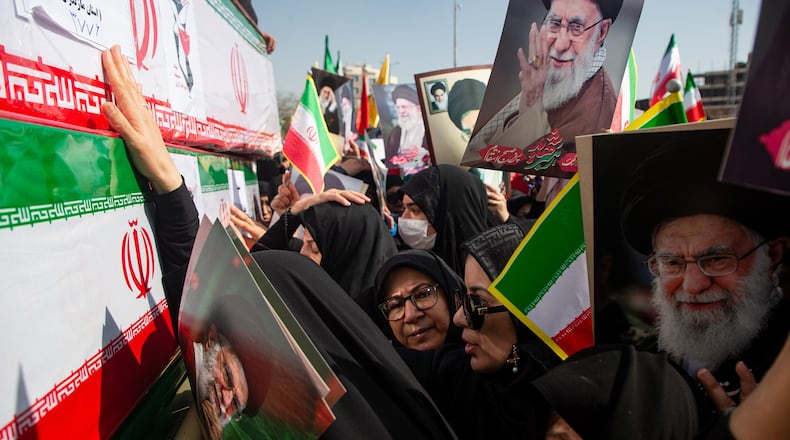Some holding pictures of the late Iranian Supreme Leader Ayatollah Ali Khamenei, mourners reach out to coffins during a funeral for people killed during the ongoing U.S.–Israeli military campaign in Isfahan, Iran, Thursday, March 5, 2026. (Payman Shahsanaei/ISNA via AP)
