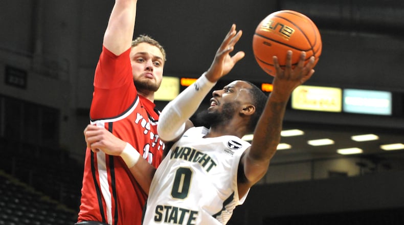 Wright State's Amari Davis, 0, takes a shot against Youngstown State's William Dunn, 11, during the first half of a Horizon Conference game at the Nutter Center on Sunday, Dec. 4. DAVID A. MOODIE/CONTRIBUTING PHOTOGRAPHER