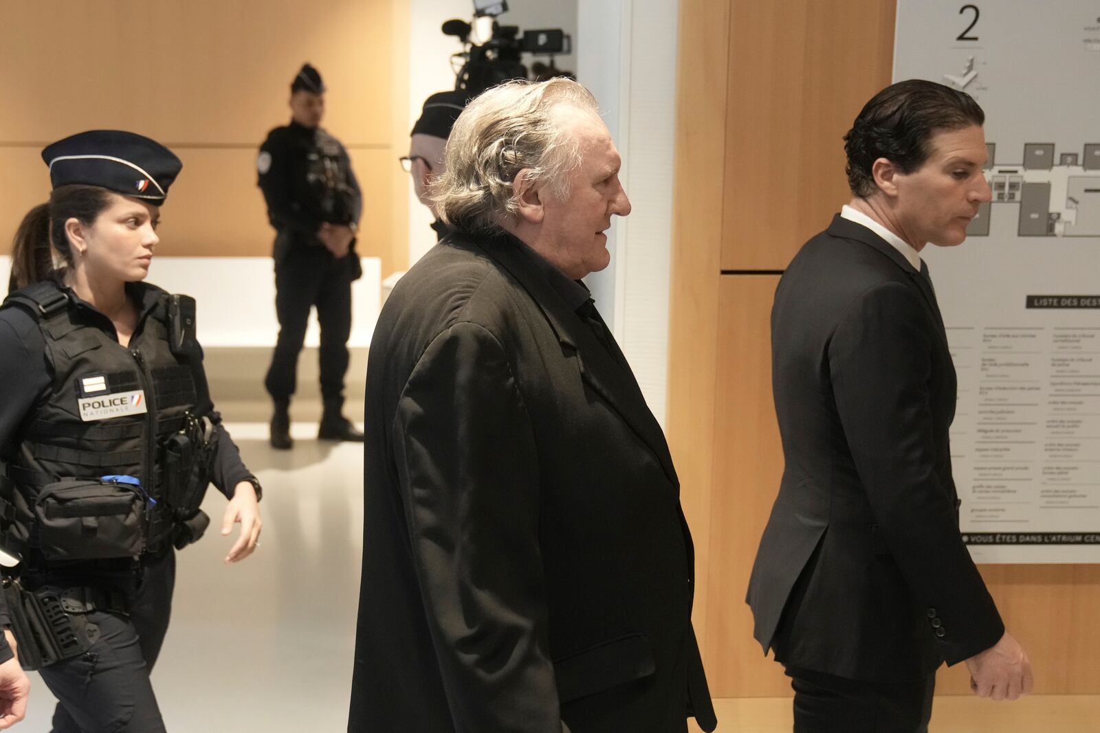 Actor Gerard Depardieu, center, who is facing trial for the alleged sexual assaults of two women on a film set in 2021, arrives with his lawyer Jeremie Assous, right, Monday, March 24, 2025 in Paris. (AP Photo/Thibault Camus)