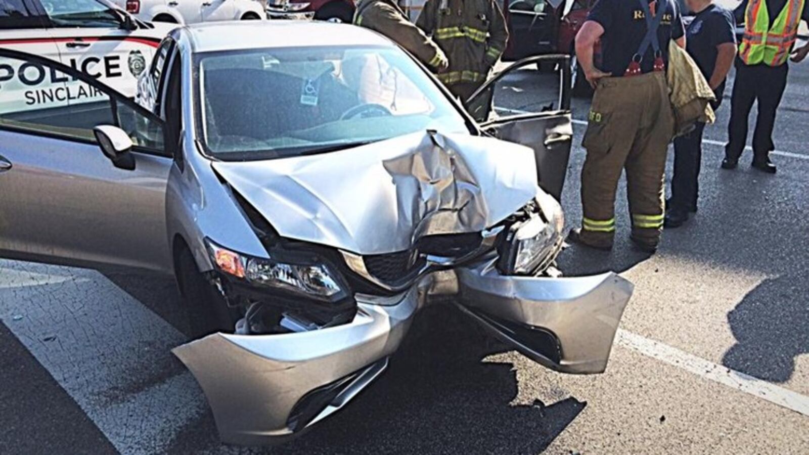 Police with the city of Dayton and Sinclair Community College respond to a wrong-way fatal crash Tuesday, June 19, 2018, in downtown Dayton. Police said Opal Clouse, 87, of Kettering was killed after a red Toyota Rav driven by Adrian Traylor, 67, was traveling west in the wrong direction on West Fifth Street. At the intersection of South Perry, Traylor s vehicle crashed into Clouse s silver Honda, sending her vehicle into a DP&L pole. MARSHALL GORBY/STAFF