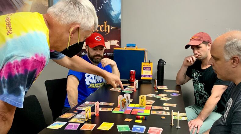 Jeffrey Secrest (left) teaches his game, Upstaged!, to a group of playtesters at Epic Loot in Centerville, on Sunday, July 9.  LONDON BISHOP/STAFF
